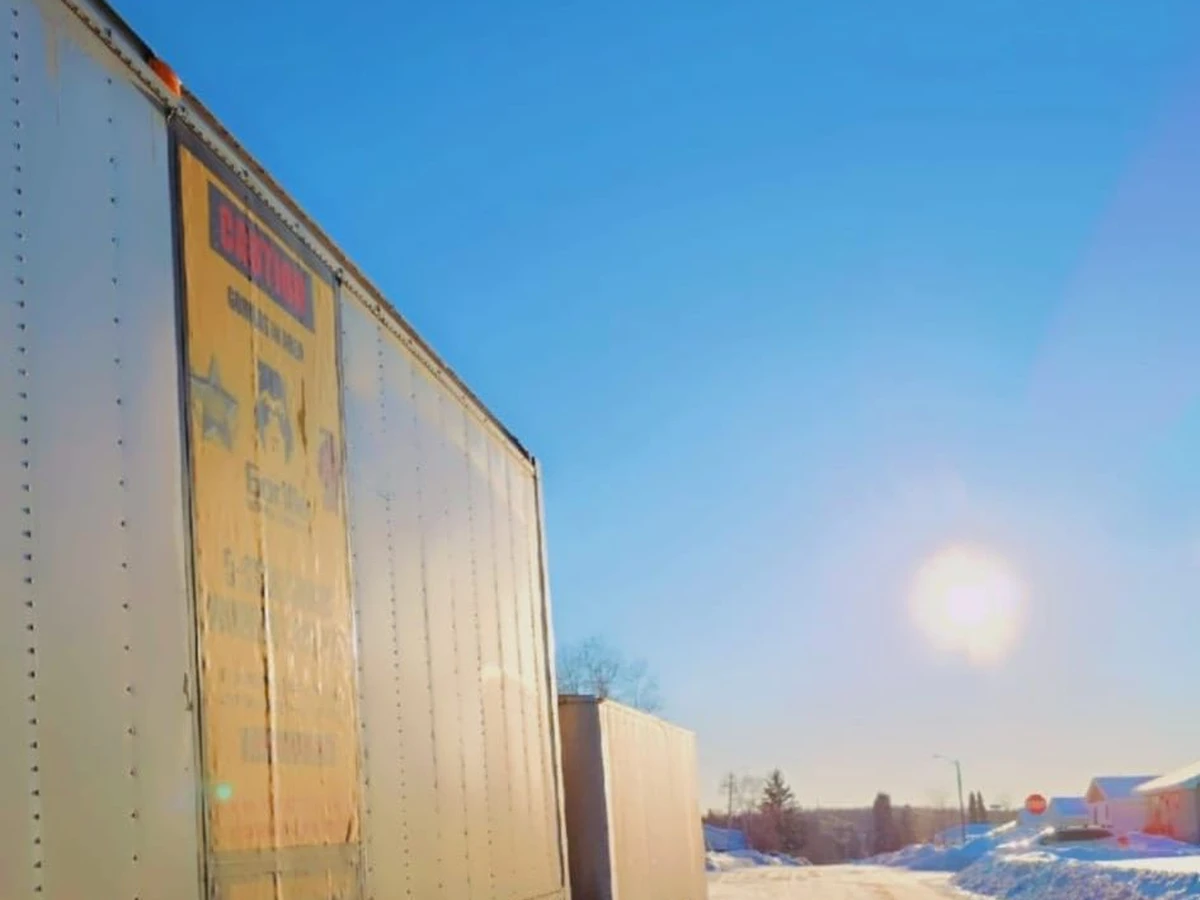 Gorilla Moves inter-provincial moving truck on a snow-covered road under a clear blue sky in Canada