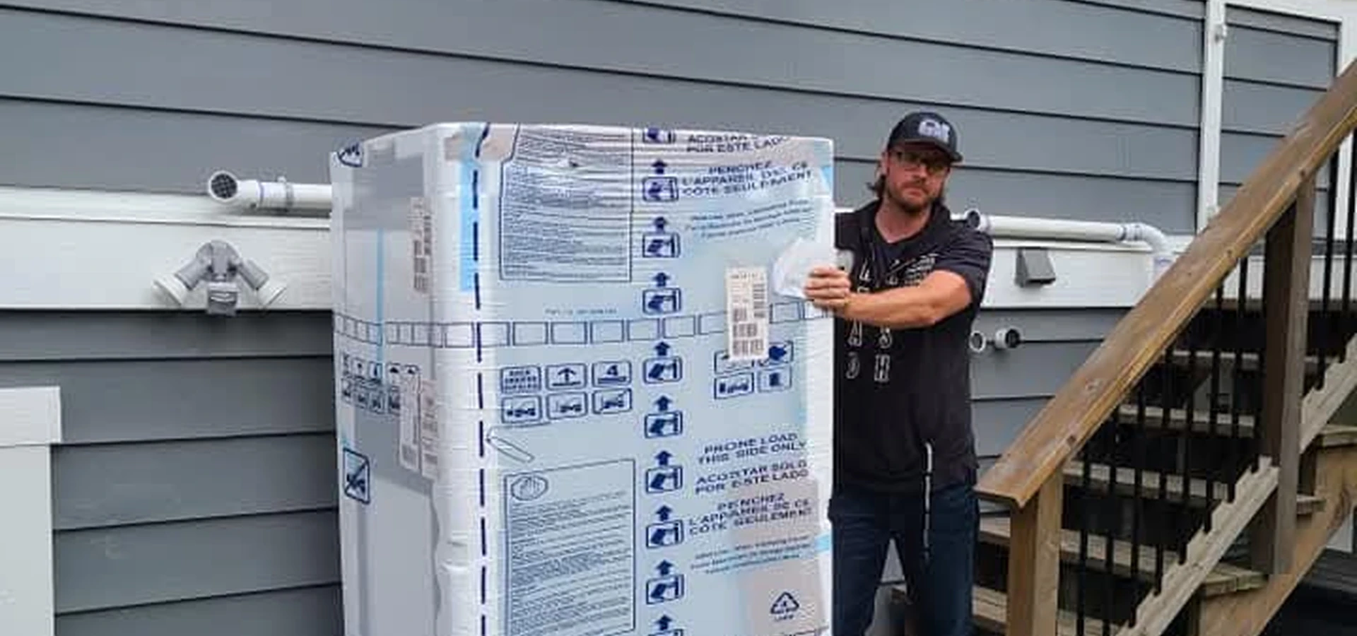 Gorilla Moves labour crew member standing beside a wrapped appliance in Fraser Valley